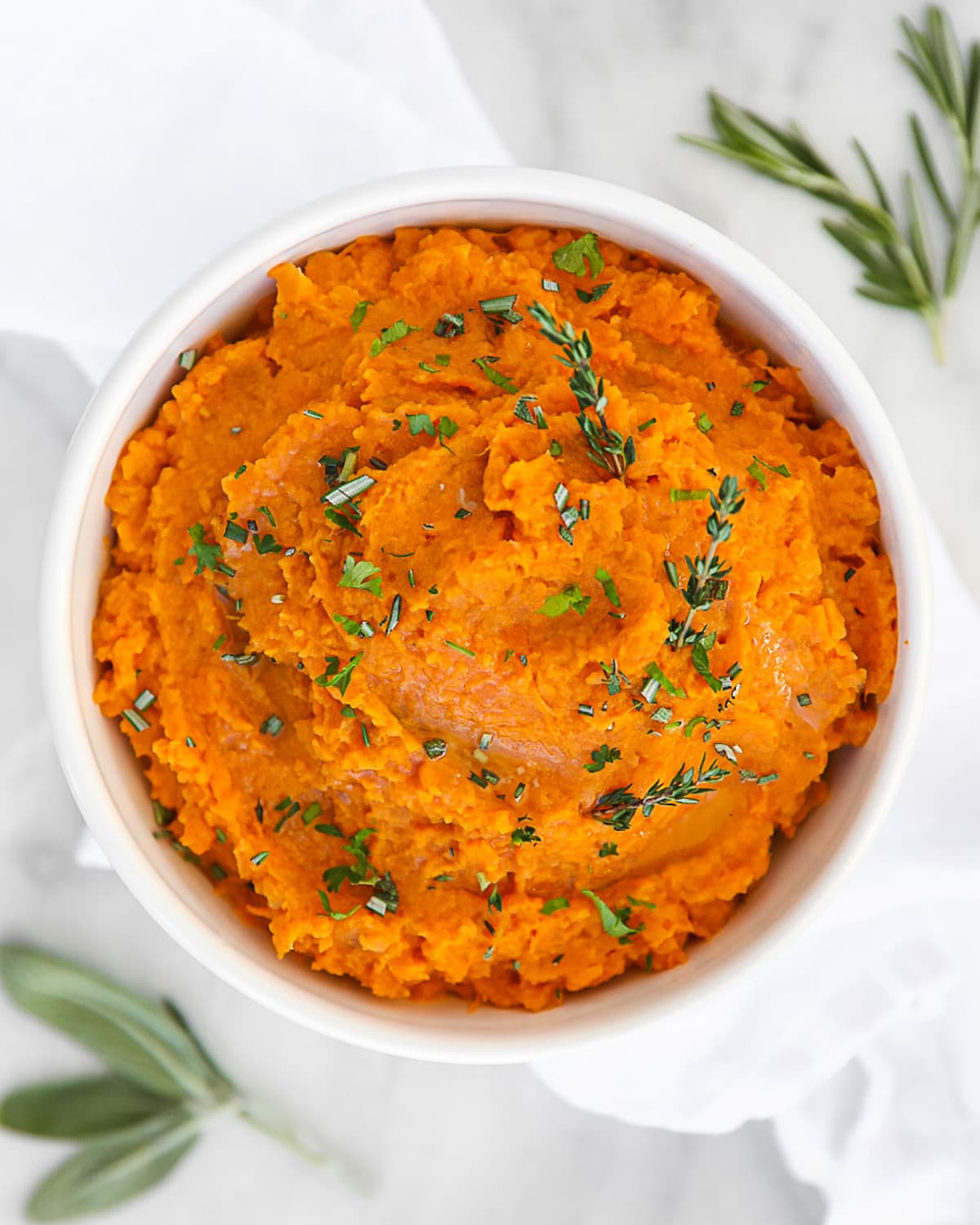 Whipped sweet potatoes in a white bowl