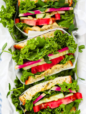 An overhead shot of sliced vegetarian sandwiches.