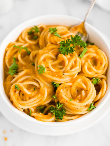 A bowl of creamy butternut squash sauce over spaghetti noodles
