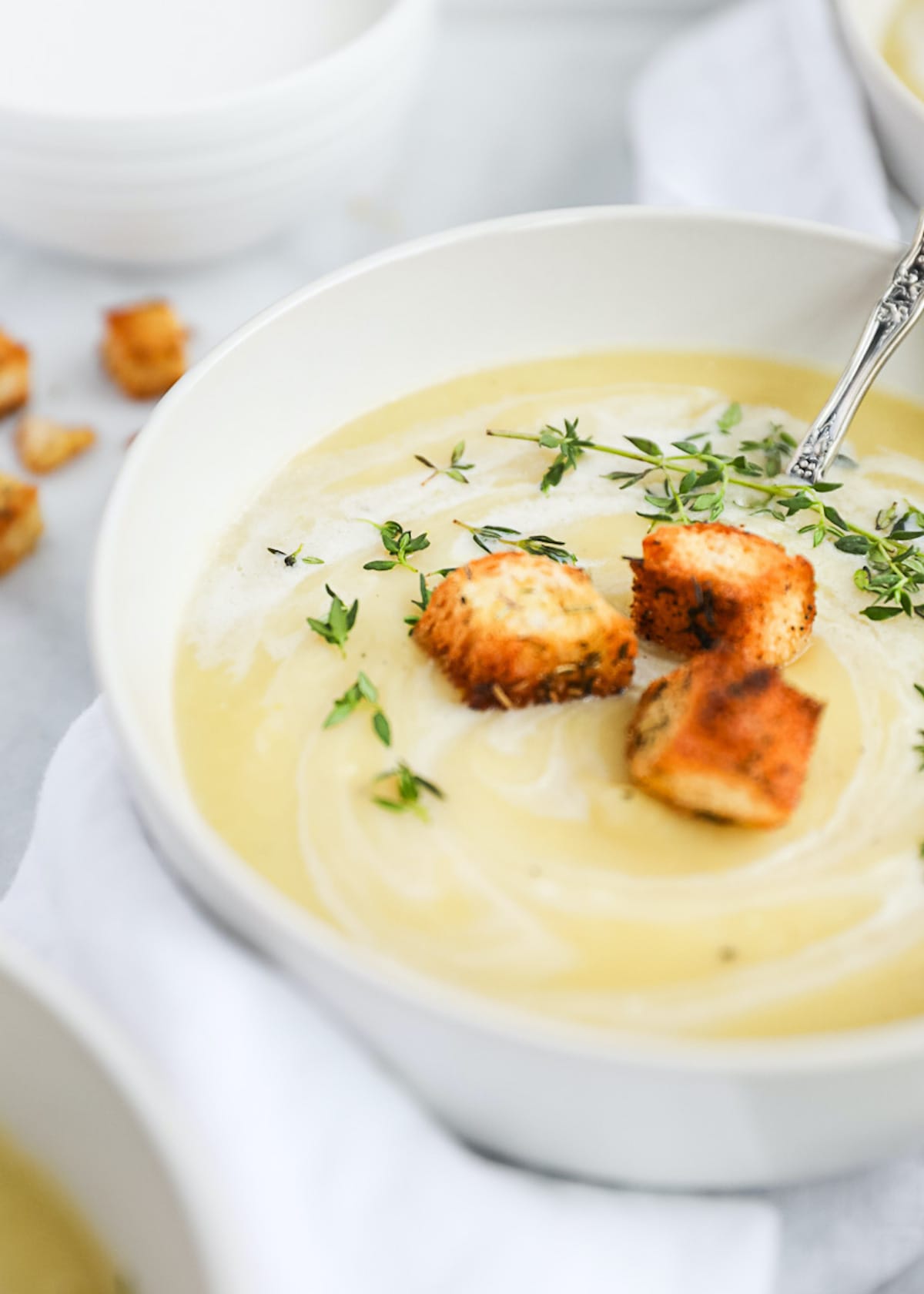 A white bowl filled with creamy vegan potato soup