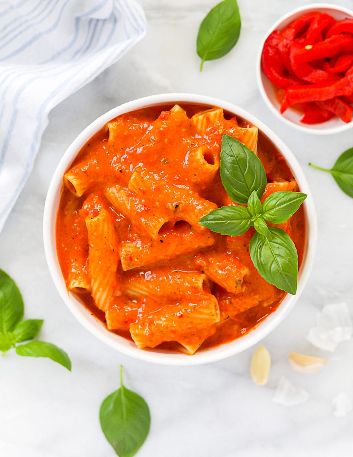 A white bowl filled with red pepper pasta sauce