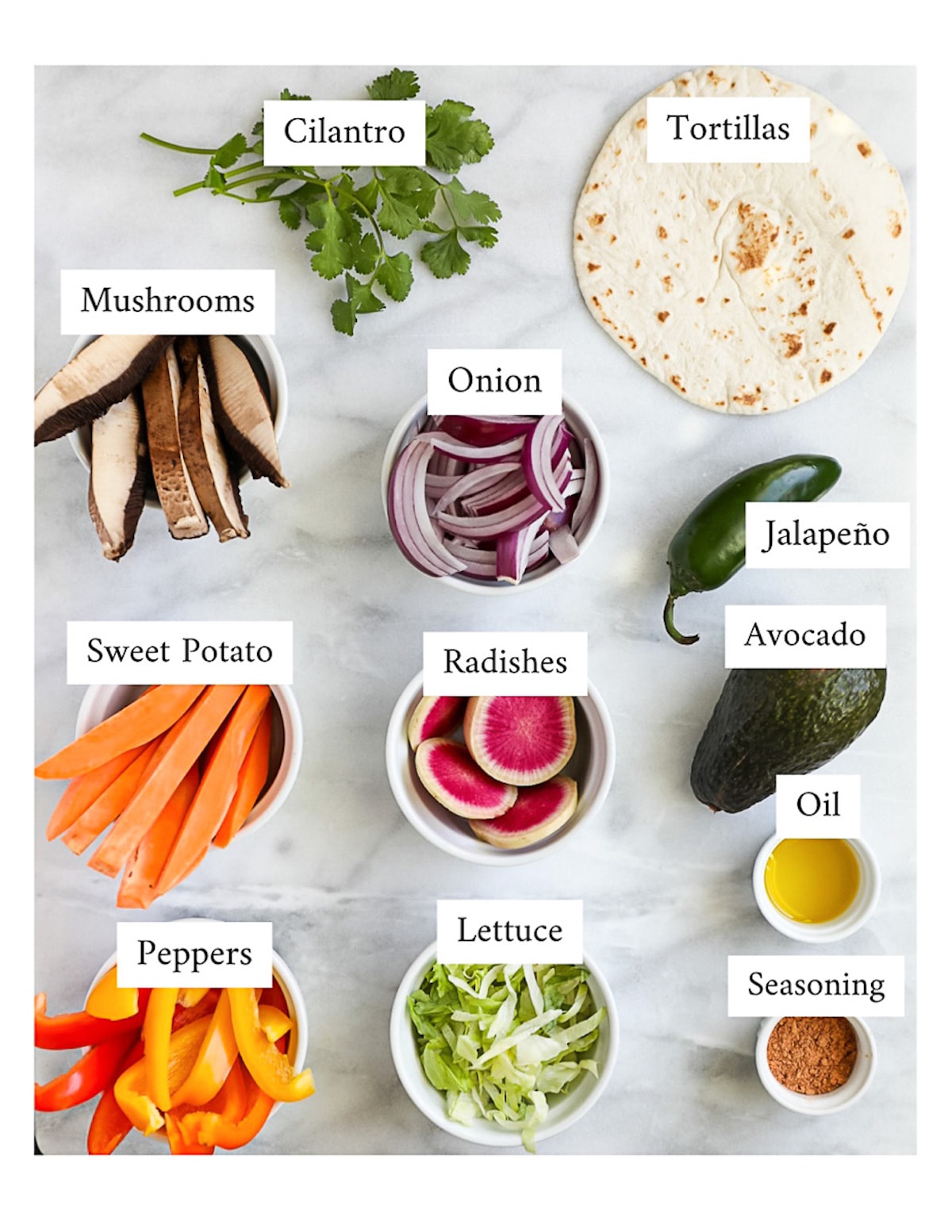 Labeled ingredients for homemade tacos including mushrooms, sweet potato, peppers, cilantro, onion, tortillas, radishes, lettuce, jalapeno, avocado, oil, and seasoning.