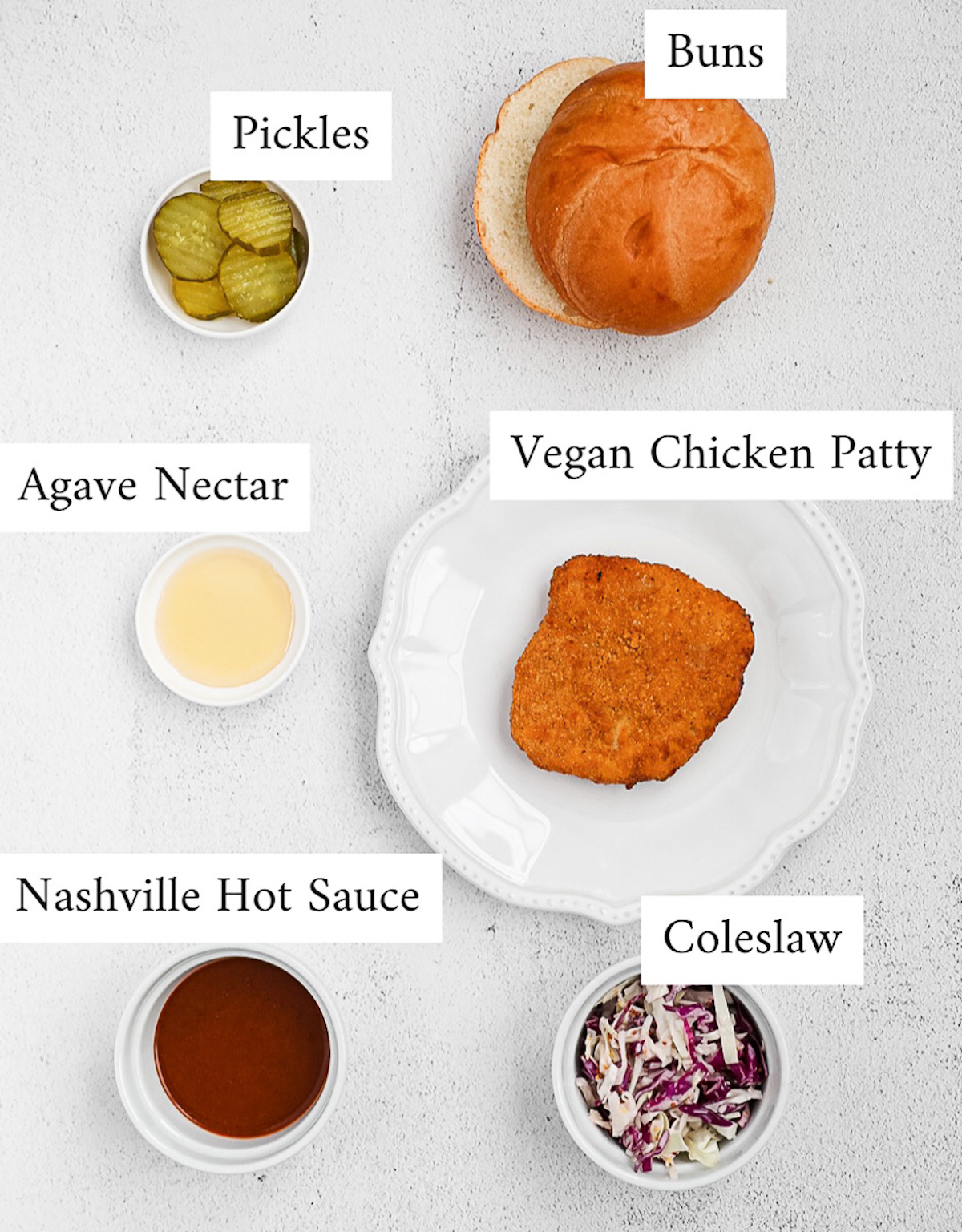 Labeled ingredients including: pickles, buns, agave nectar, a vegan chicken patty, hot sauce, and coleslaw.
