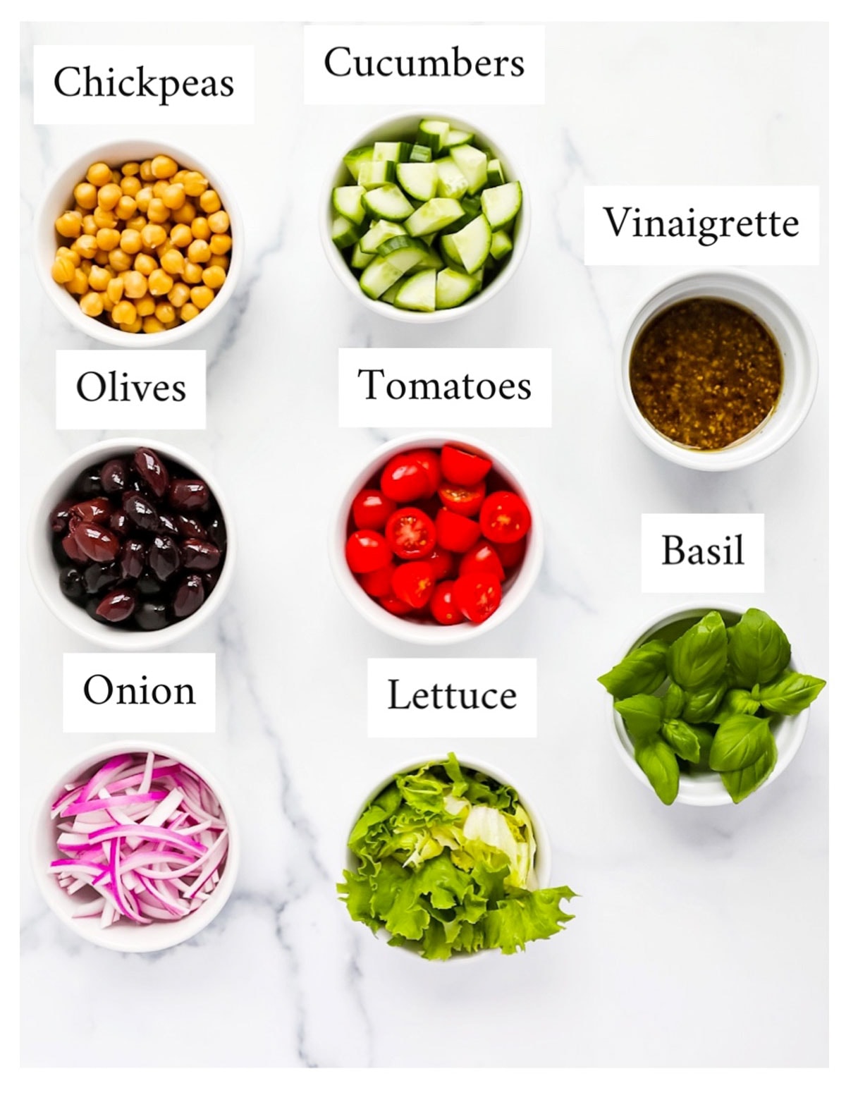 Labeled ingredients including: chickpeas, cucumbers, olives, tomatoes, vinaigrette, basil, lettuce, and onion