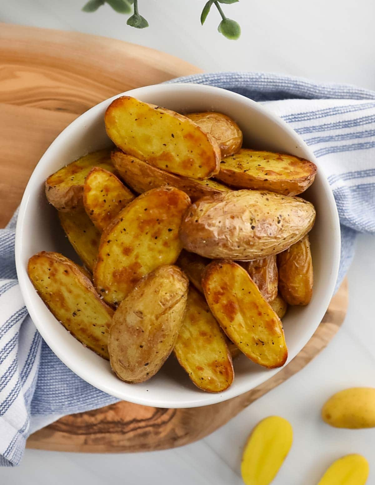 Cooked fingerling potatoes in a small white bowl.