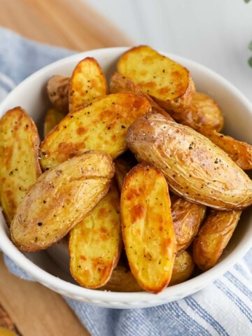 Crispy, cooked potatoes in a white bowl.