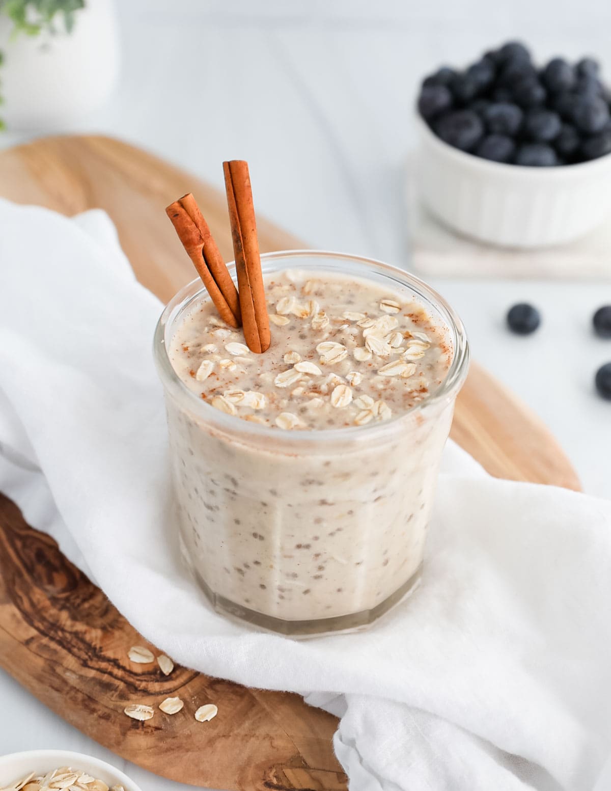 Overnight oats and cinnamon sticks in a jar.