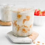 A clear cup filled with chia pudding and peanut butter.